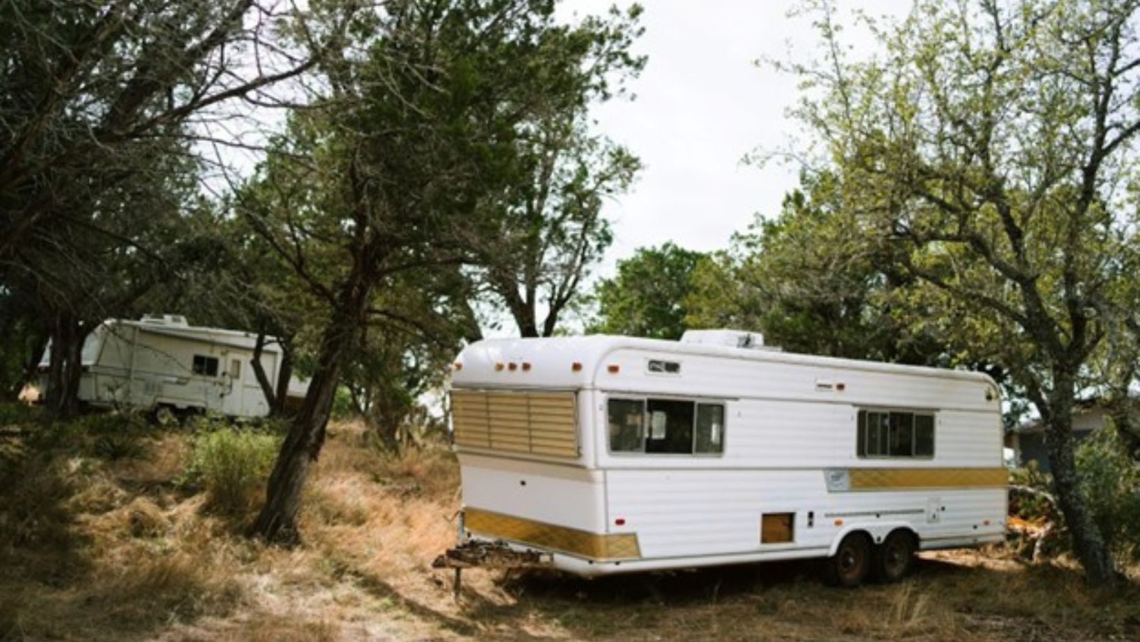 RV parked between trees