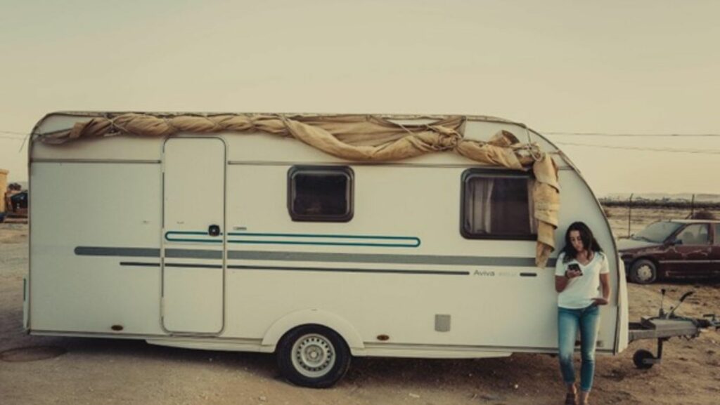 woman leaning against RV