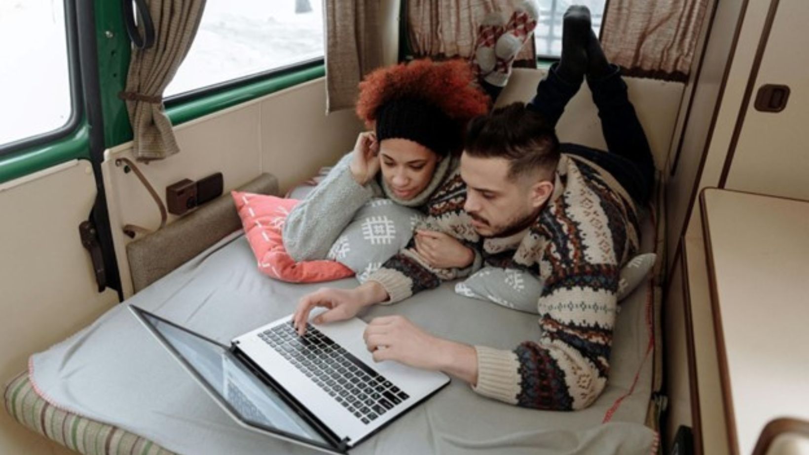 couple using a laptop in RV